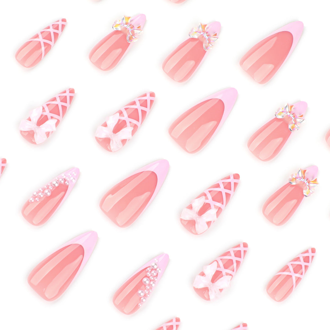 Artful stiletto nails with glitter and bow decoration Stornfield