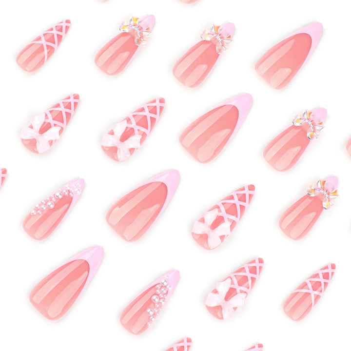 Artful stiletto nails with glitter and bow decoration Stornfield