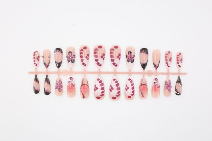Acrylic nail set with elegant floral design and glossy accents Stornfield