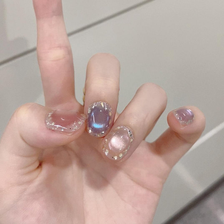 Artificial acrylic nails with shimmering effects and elegant glitter accents Stornfield