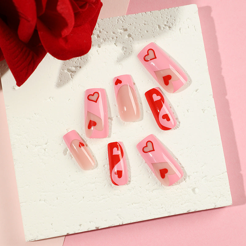 Artificial nail art with heart design and glitter accents Stornfield