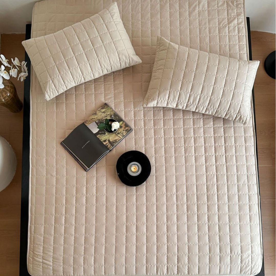Padded quilted mattress topper with non-slip bottom and breathable fiber filling
