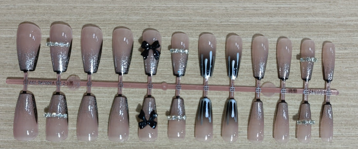Elegant nail design with bow and rhinestone details Stornfield