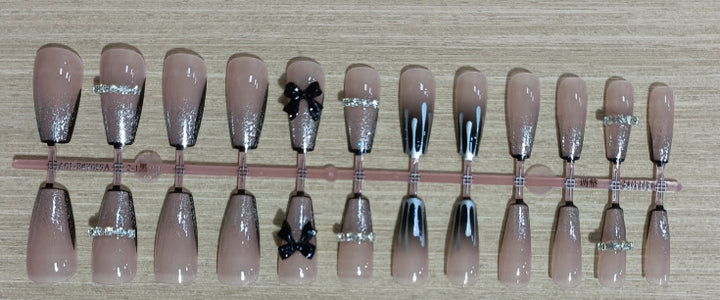 Elegant nail design with bow and rhinestone details Stornfield