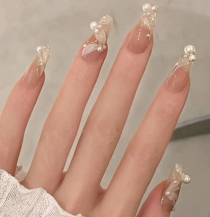 Elegant nail design with pearl embellishment Stornfield