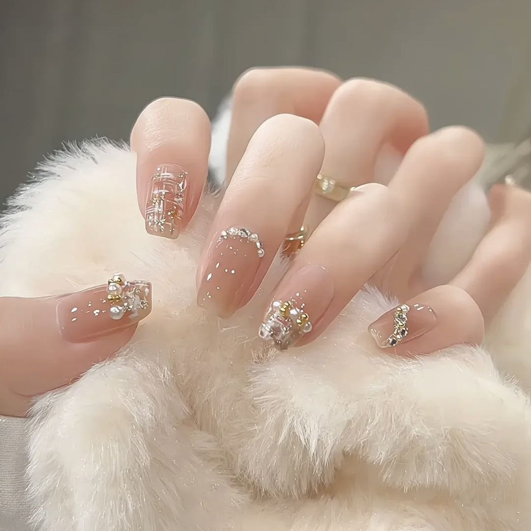 Glamorous artificial nails with striking pearl and glitter elements