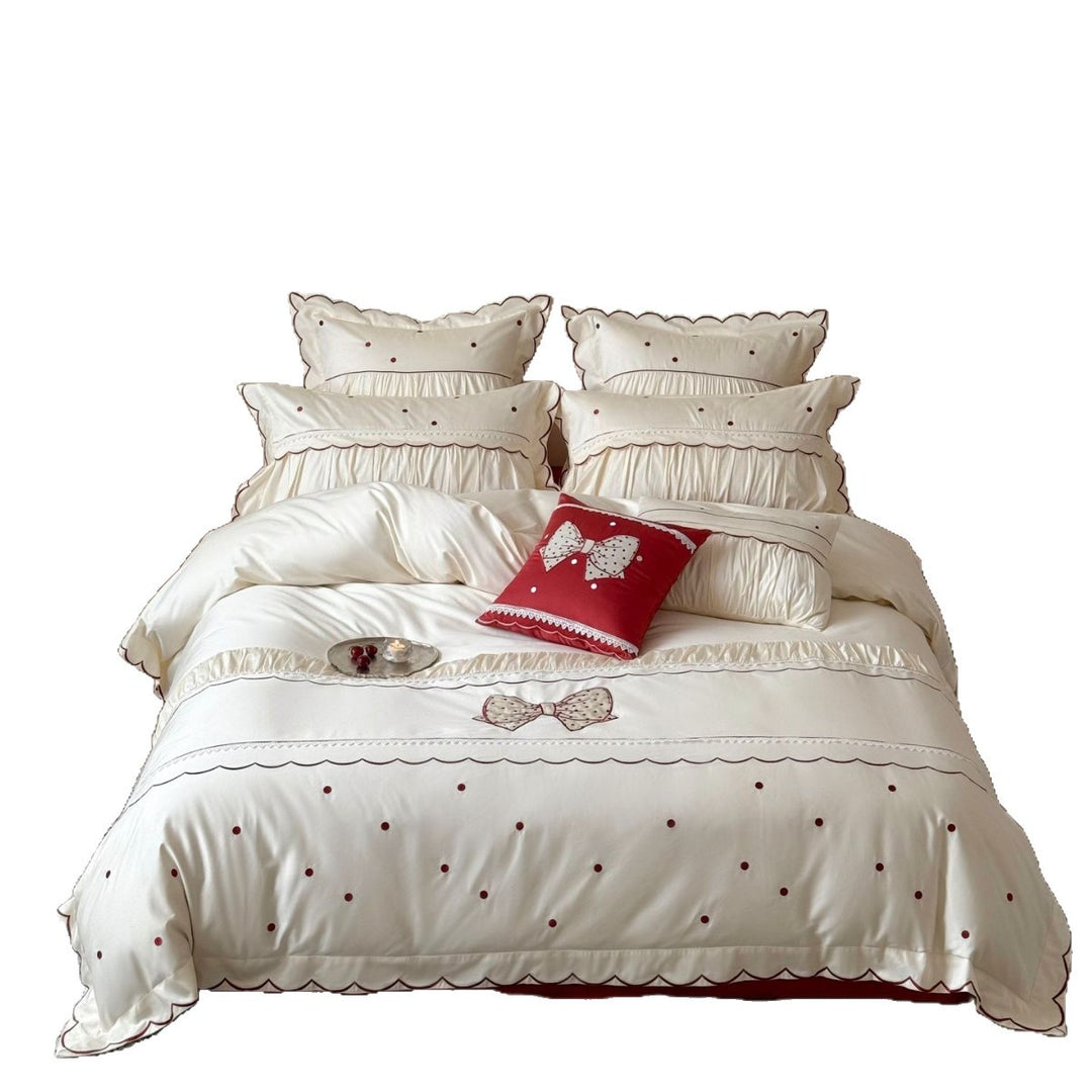 Elegant cotton satin bedding set with decorative bow appliqué and gathered frill