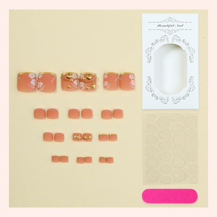 Acrylic nail set with exquisite floral accents and golden embellishments Stornfield