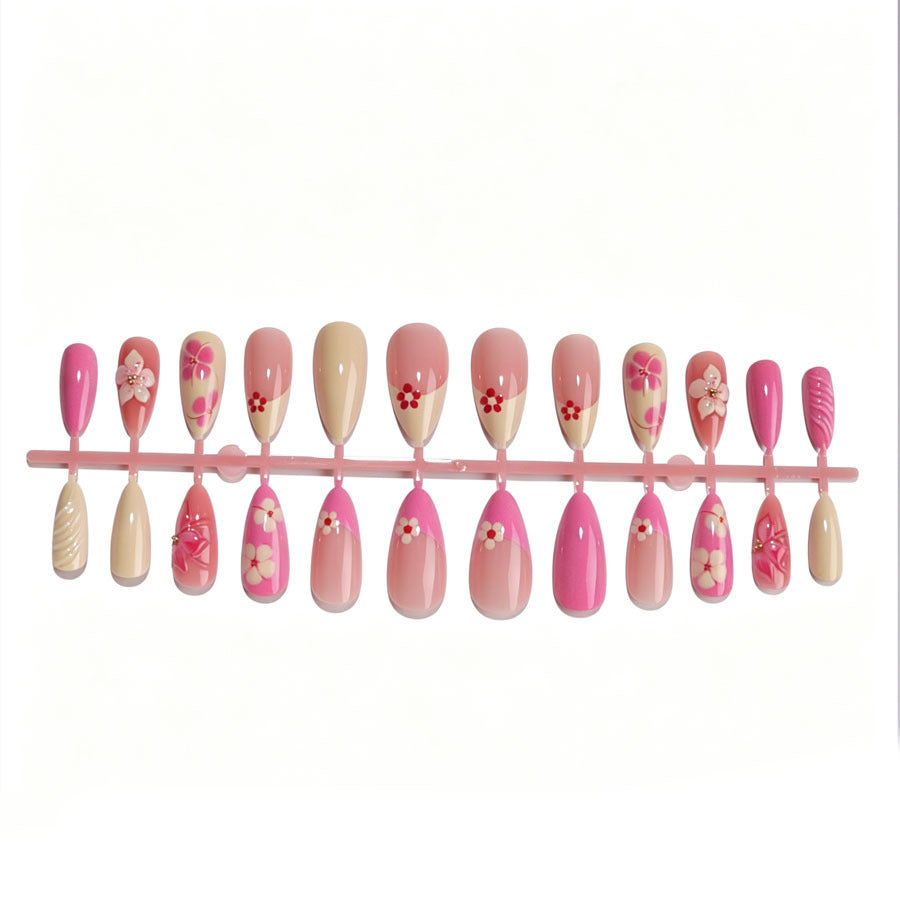 Artificial nail set with floral accents and glitter elements Stornfield