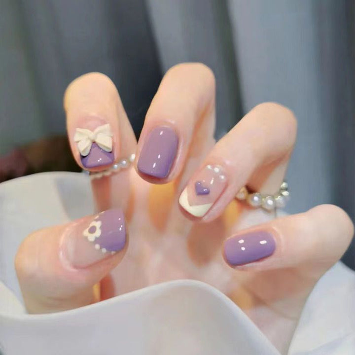 Artistic Nail Art with Glitter and Flower Applications Stornfield