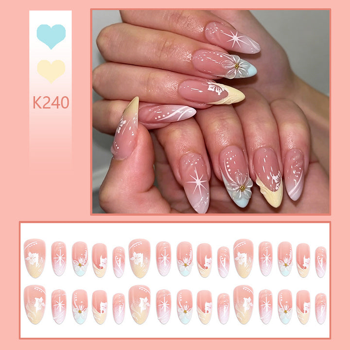 Artificial nail set with intricately detailed floral designs and shine accents Stornfield
