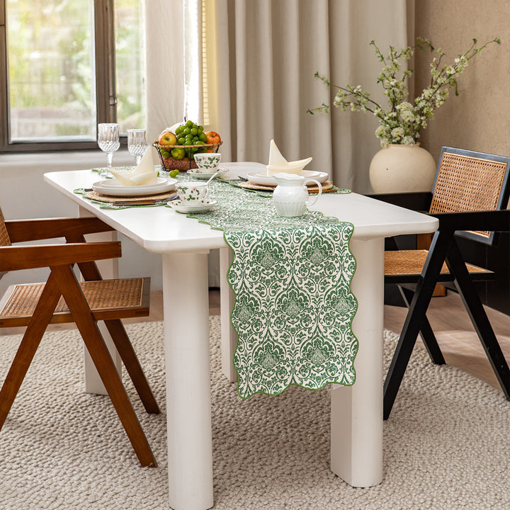 Elegant table runner with wavy hem and baroque damask pattern