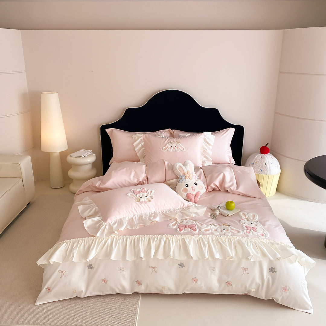Playful bedding set with ruffles, three-dimensional appliqués, and delicate embroidery