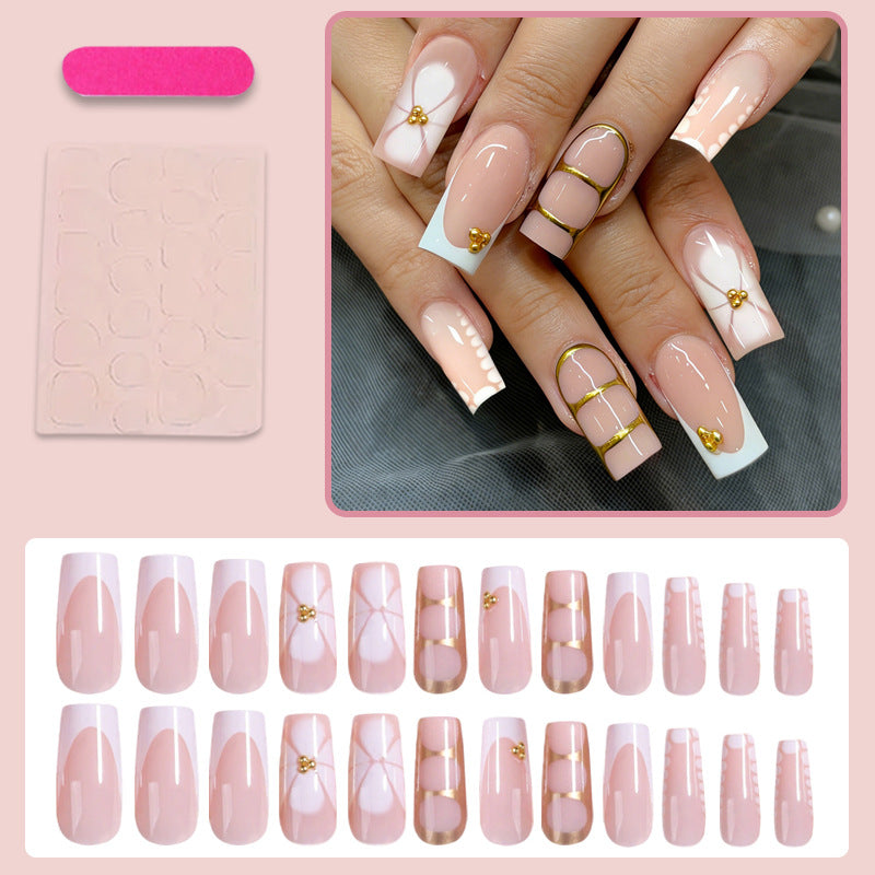Artificial nail set with elegant gold embellishments and romantic accents Stornfield