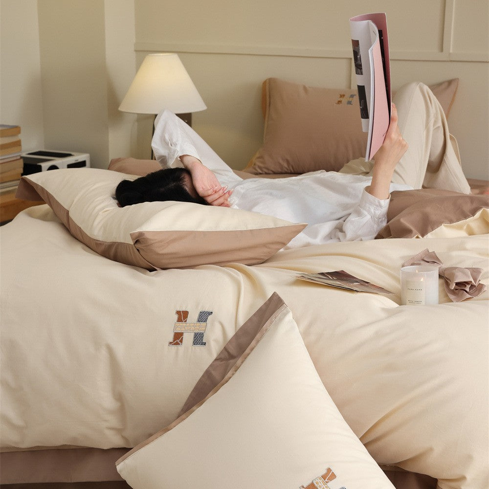 Luxurious cotton satin bedding set with contrasting piped edge and monogram embroidery