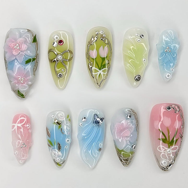 Artificial nail set with floral motifs and glitter accents Stornfield