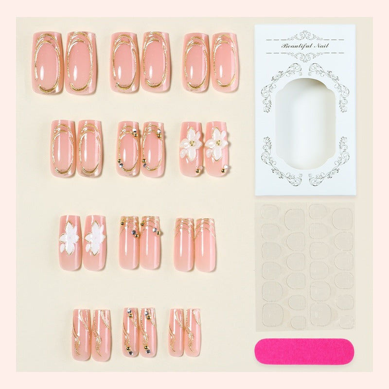 Elegant artificial nail set with decorative flower and gold embellishments Stornfield