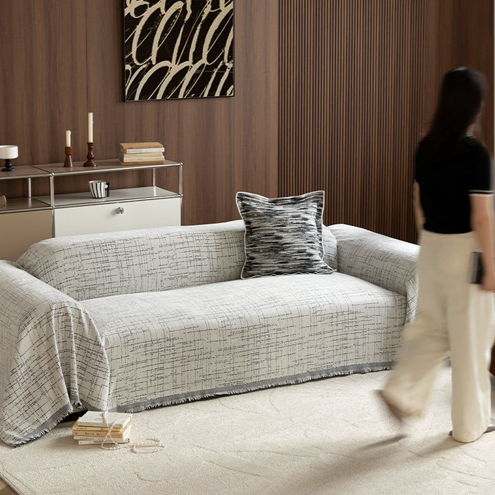 Universal sofa throw made of woven cotton blend with fringes and gentle upholstery cover Stornfield