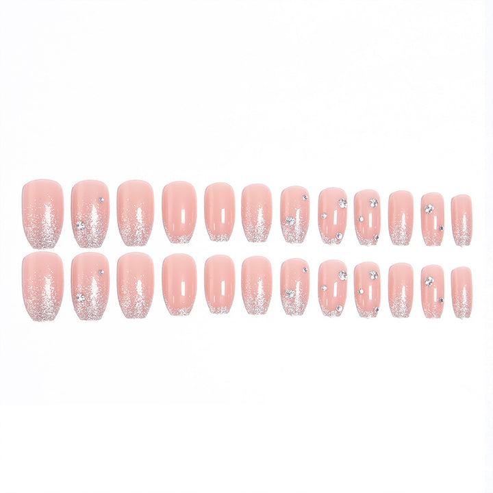 Glamorous artificial nails with glitter and rhinestone embellishments Stornfield