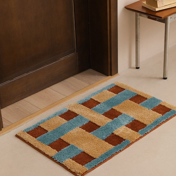 Rectangular tufted door mat with geometric block pattern and non-slip backing Stornfield