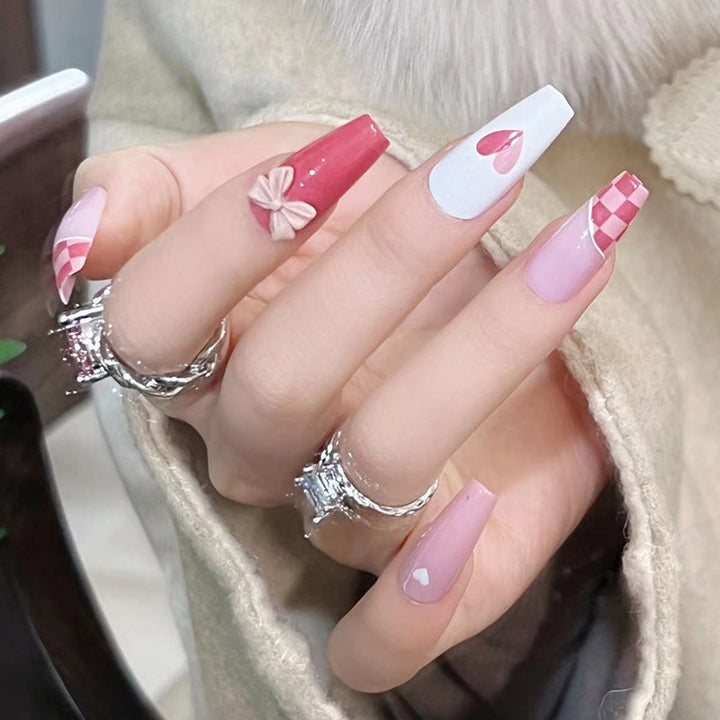 Artful nail extensions with playful designs and romantic accents Stornfield