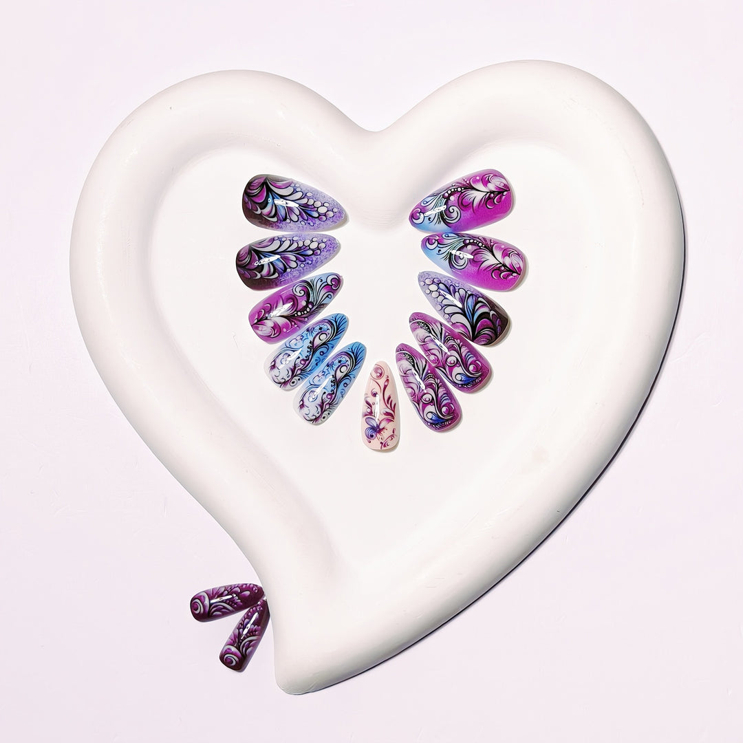 Creative artificial nails with floral and shimmering design elements Stornfield