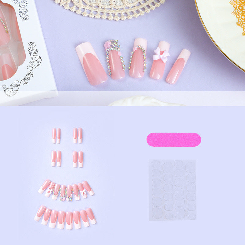 Artificial nail set with careful ribbon and glitter decorations Stornfield