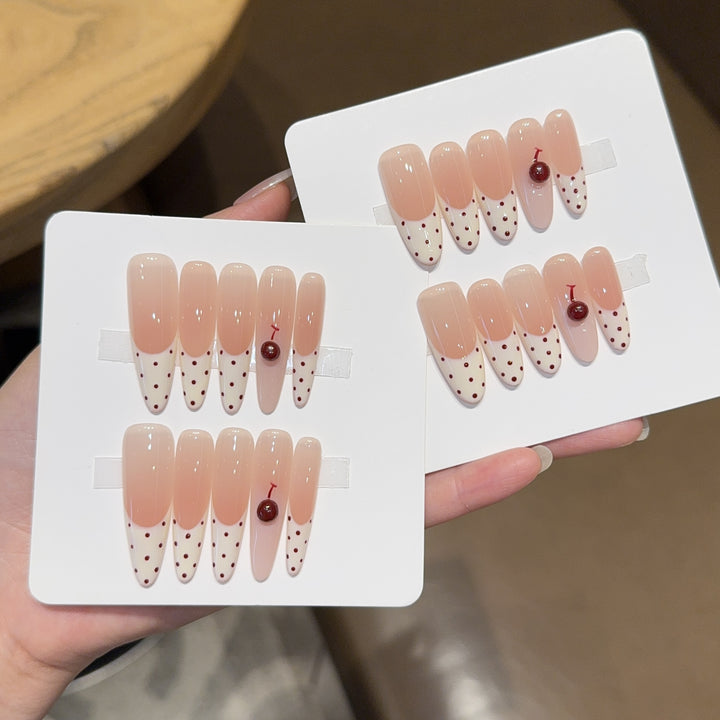 Artificial nails with playful design and cherry accents Stornfield