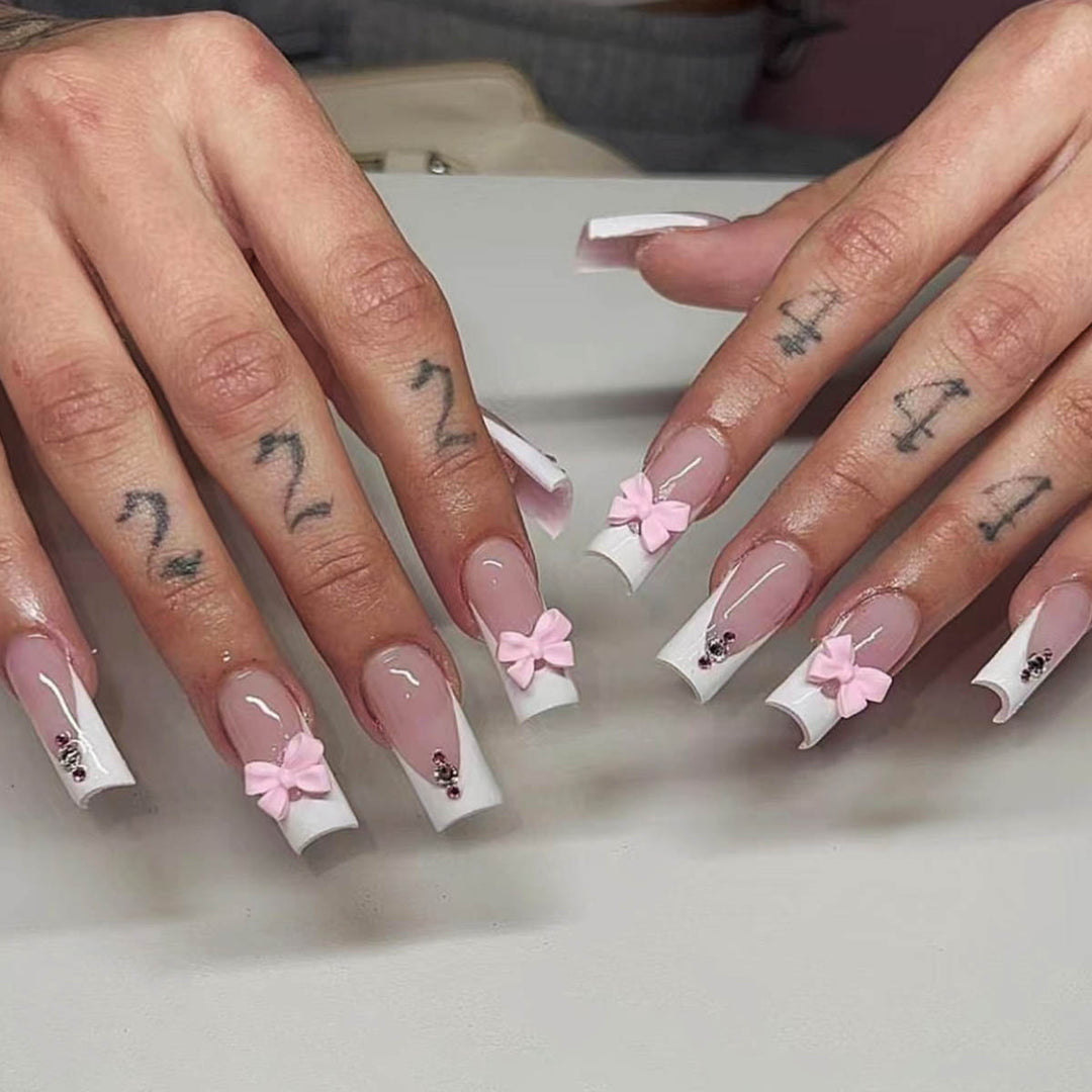 Trendy French-design artificial nails with bow accents Stornfield