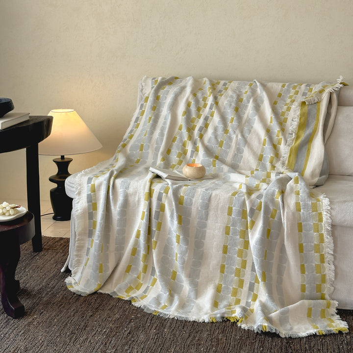 Generous cotton-linen throw blanket with geometric pattern and fringes