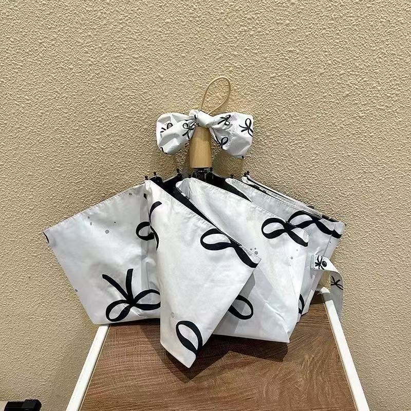 Women's foldable umbrella with elegant bow design Stornfield