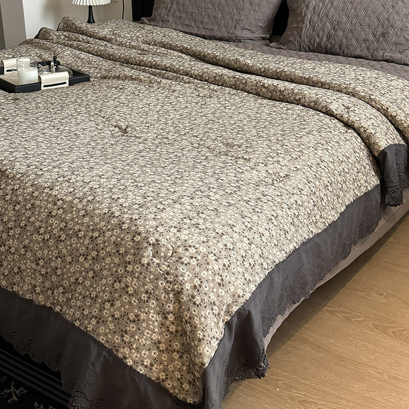 Quilted bedspread with lace trim and vintage stripe pattern