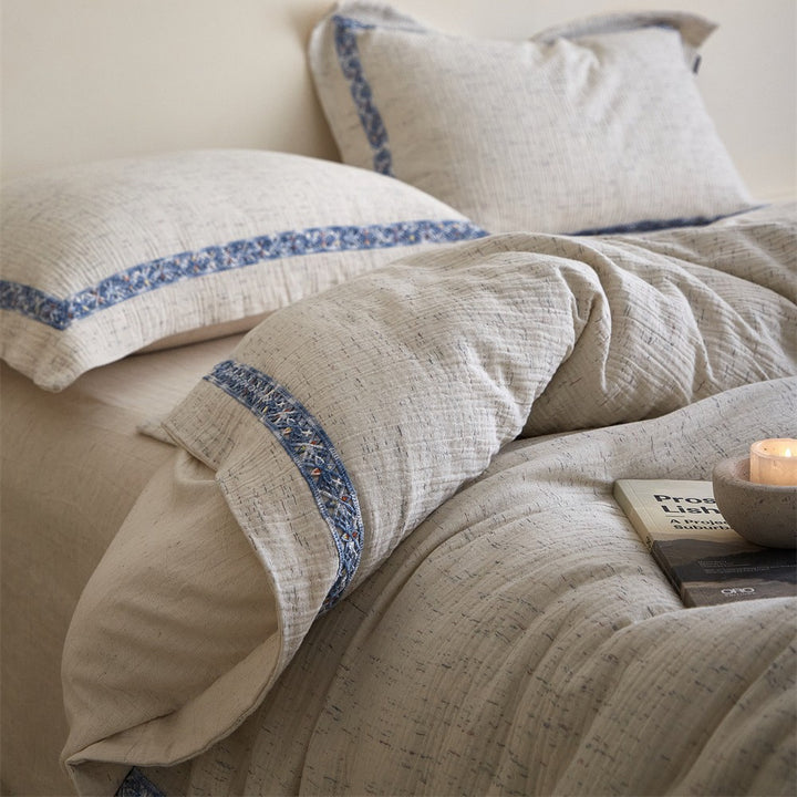 Linen bedding set with woven texture and subtle indigo border