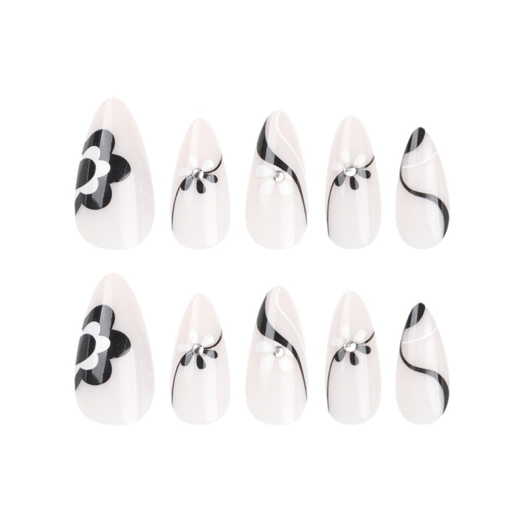 Artistic nail extensions with floral accents and glitter accents Stornfield