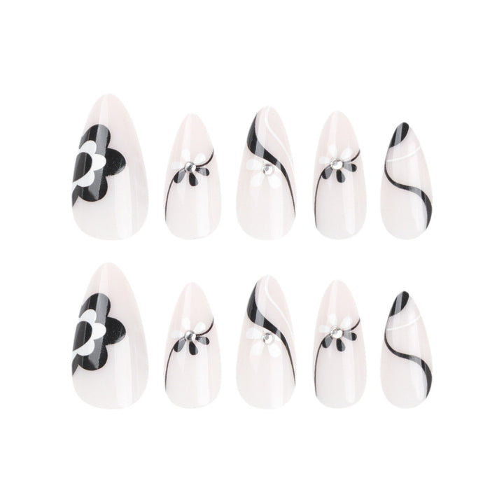 Artistic nail extensions with floral accents and glitter accents Stornfield