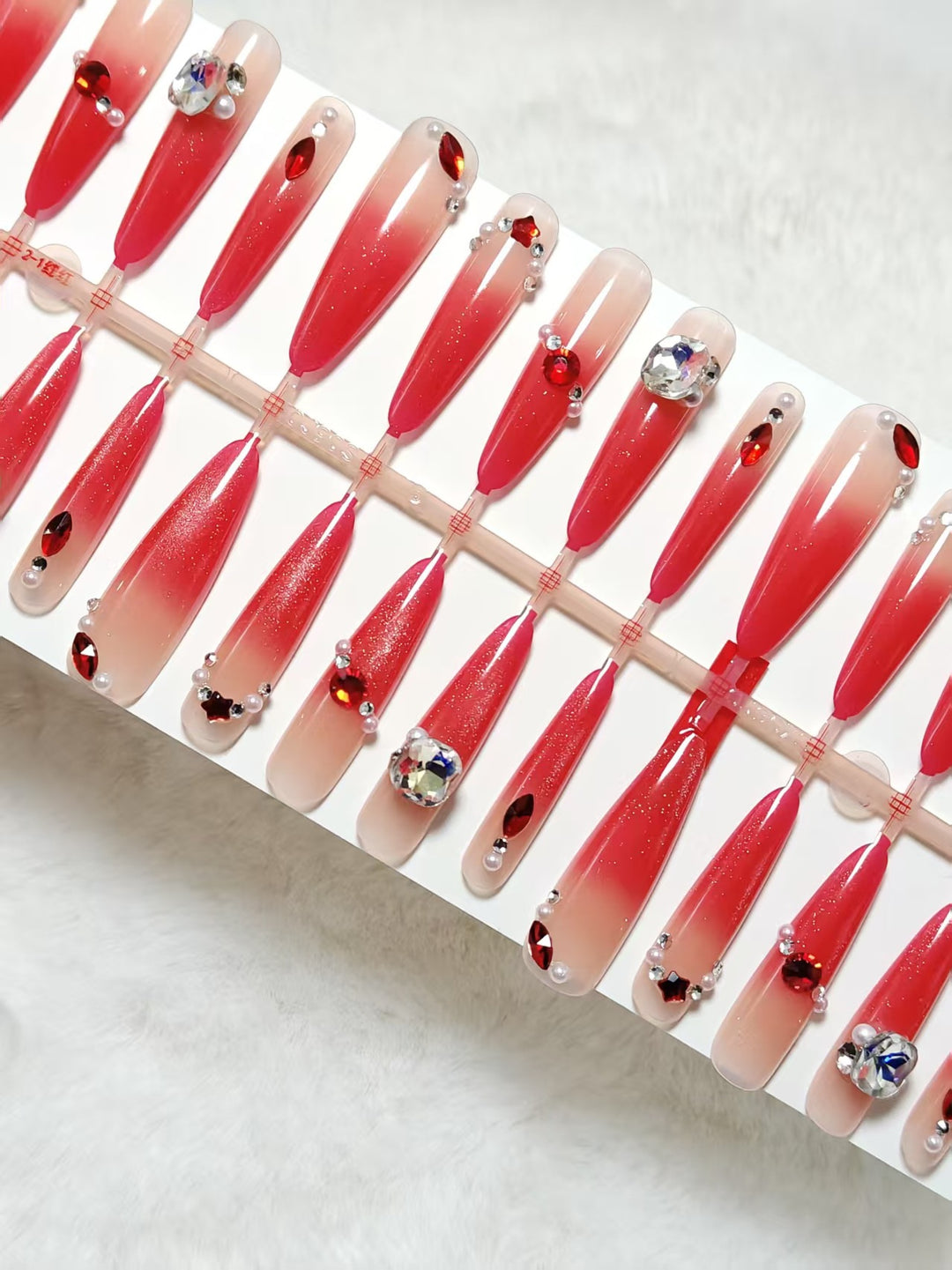 Glamorous artificial nails with sparkling ombre effect and elegant embellishments Stornfield