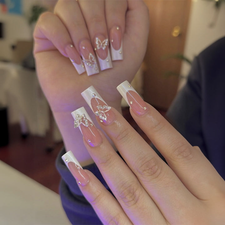 Artificial nail set with luxurious glitter and delicate floral designs Stornfield
