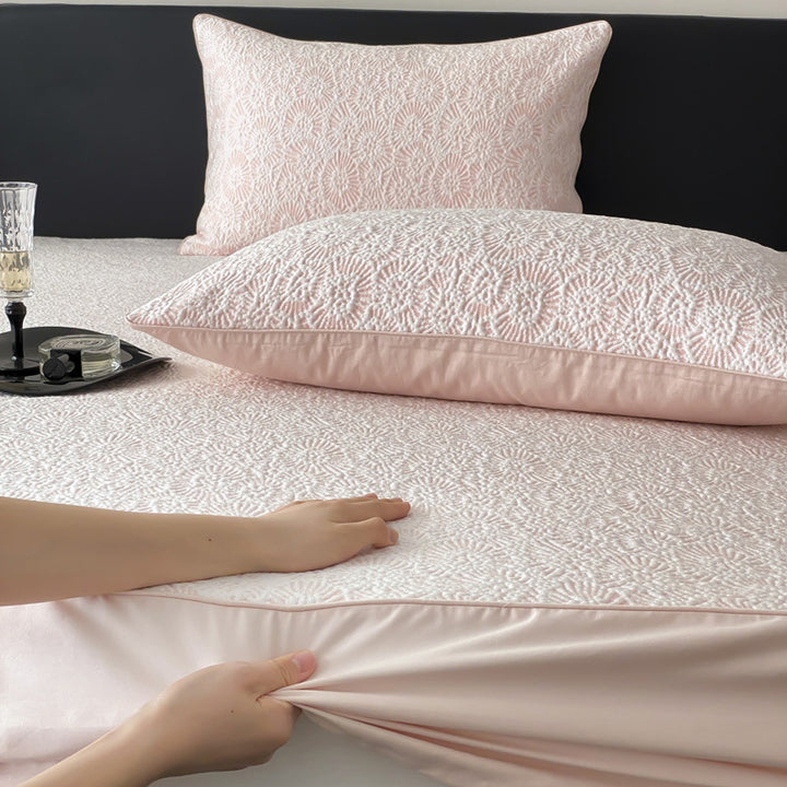 Quilted mattress protector with all-round elastic and floral relief structure