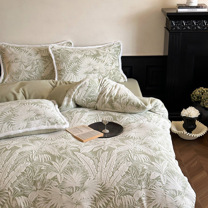 Quilted bed set with jacquard palm pattern and reversible comfort side