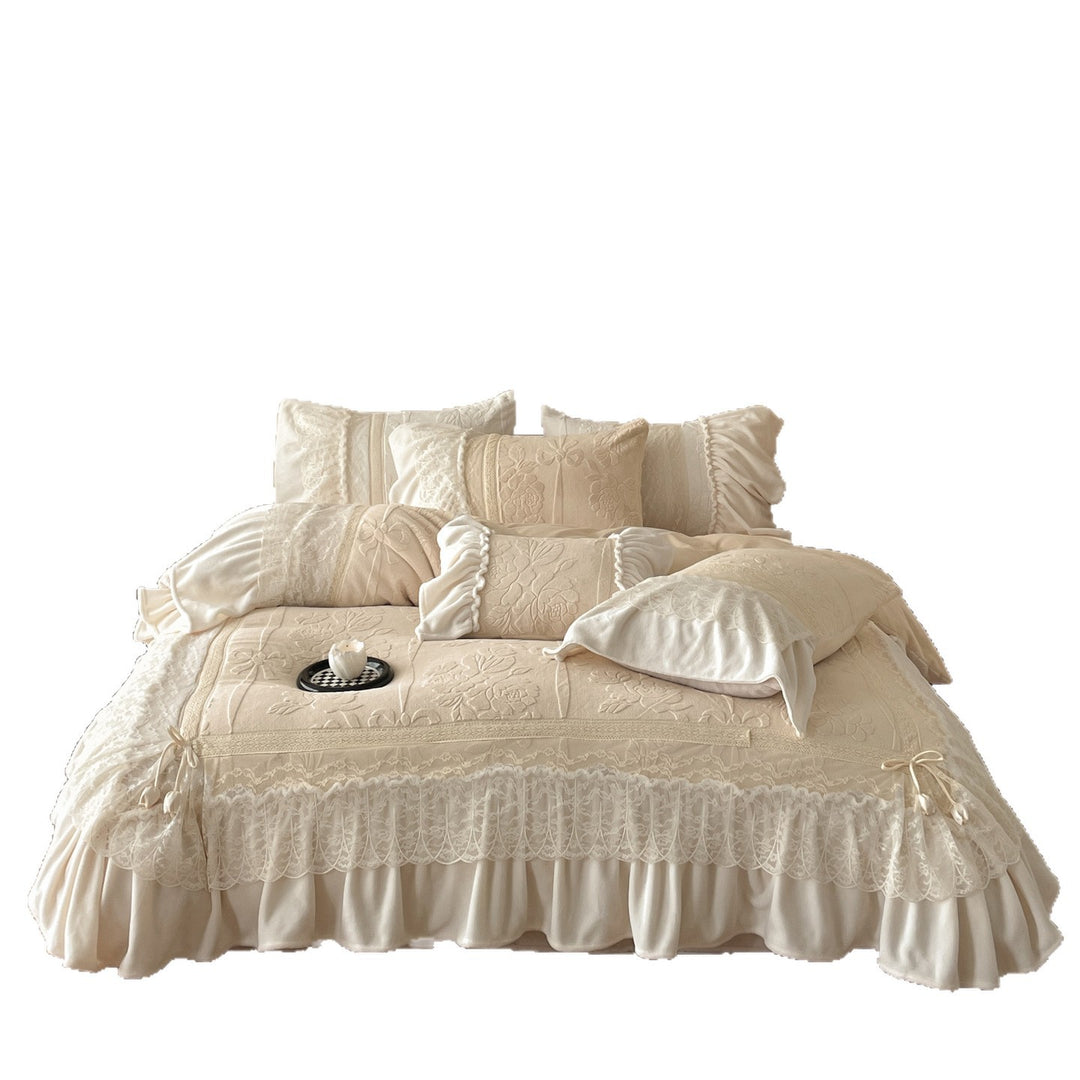 Luxury bedding set with quilted coverlet, lace ruffle, and decorative bed skirt