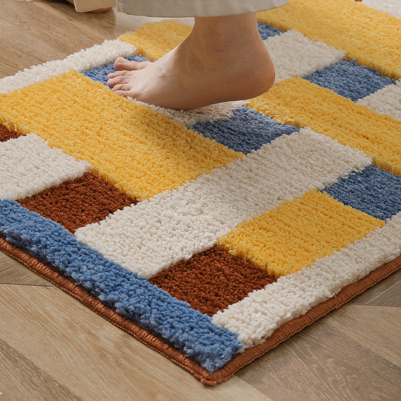Rectangular tufted door mat with geometric block pattern and non-slip backing Stornfield