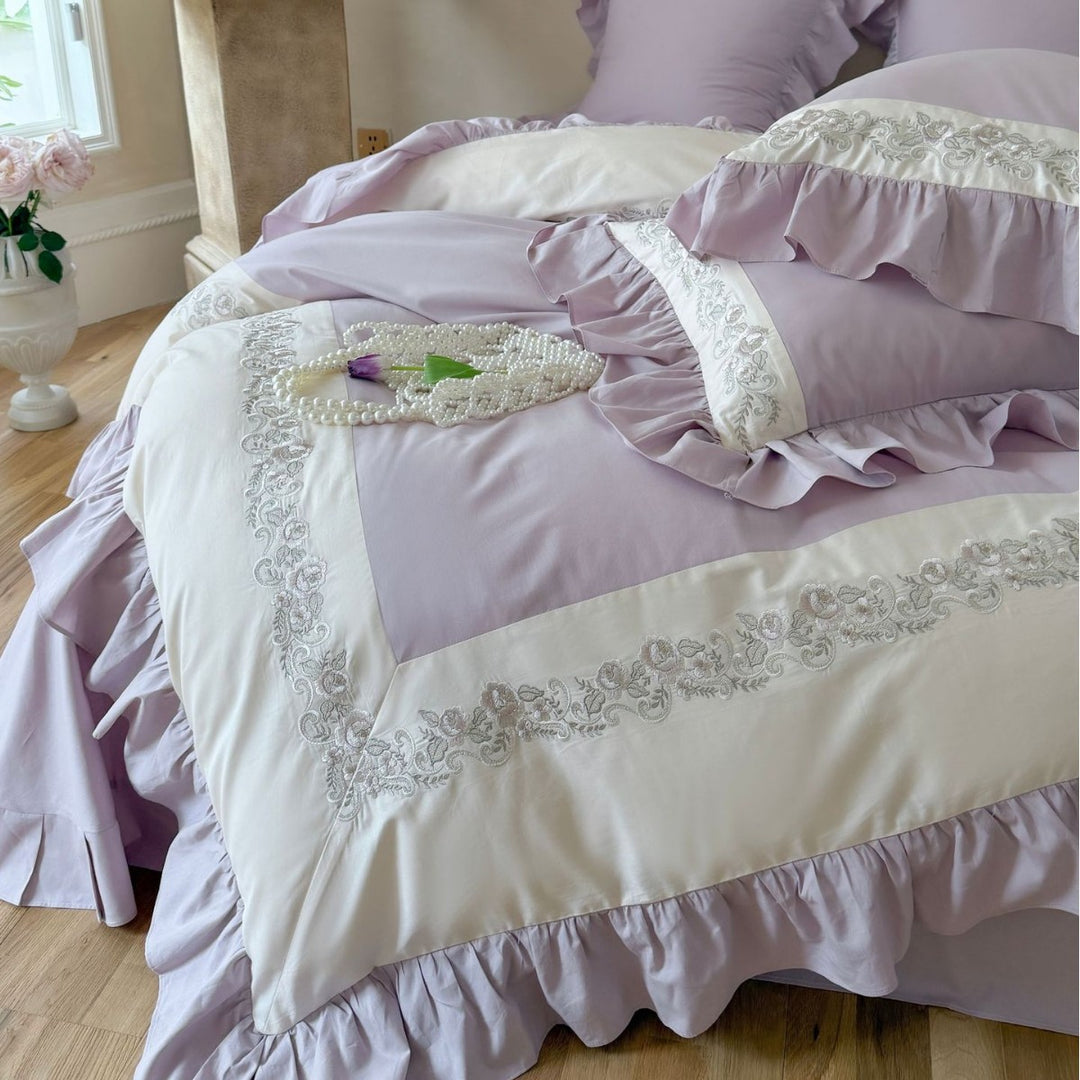 Designer bed linen set with ruffle hem and fine border embroidery