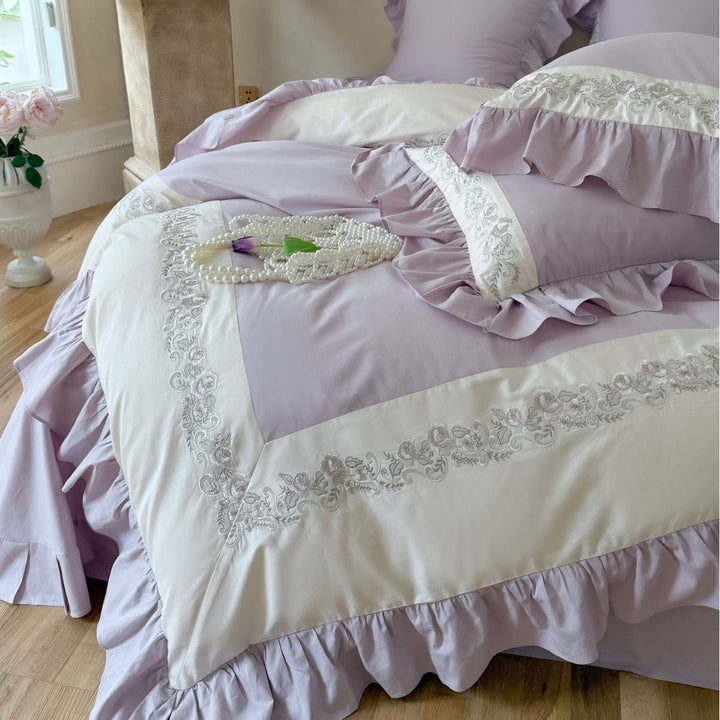 Designer bed linen set with ruffle hem and fine border embroidery
