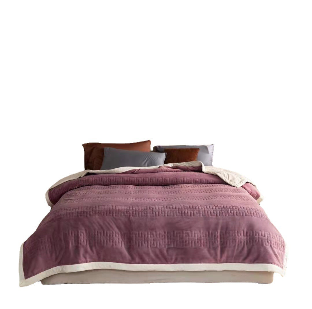 Reversible quilted comforter with structured box stitching and cotton trim