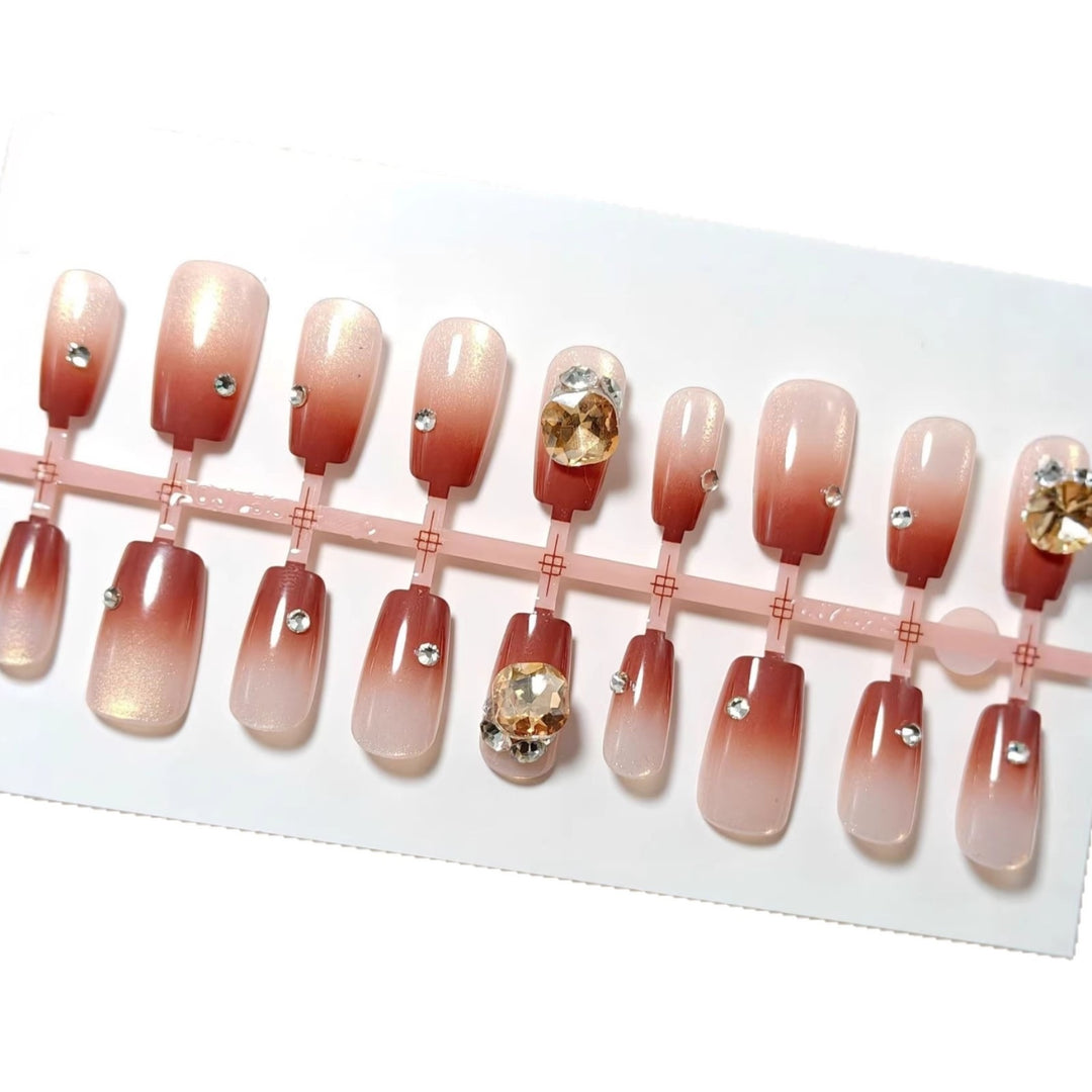 Artificials nails in elegant ombre style with rhinestone embellished applications Stornfield
