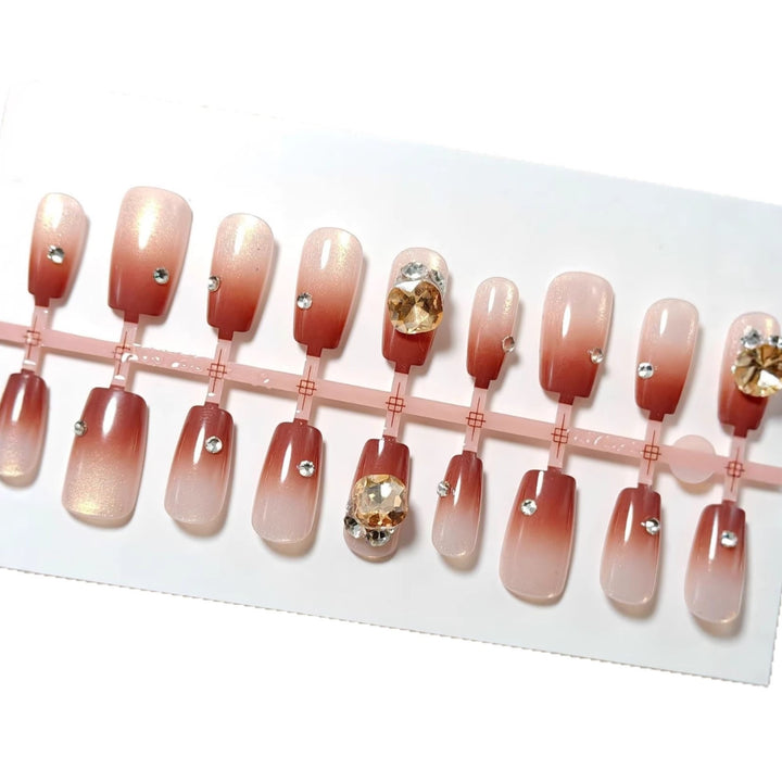 Artificials nails in elegant ombre style with rhinestone embellished applications Stornfield