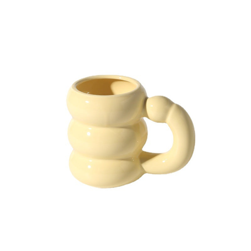 Sculptural ceramic mug with iridescent glaze and curved ring handle