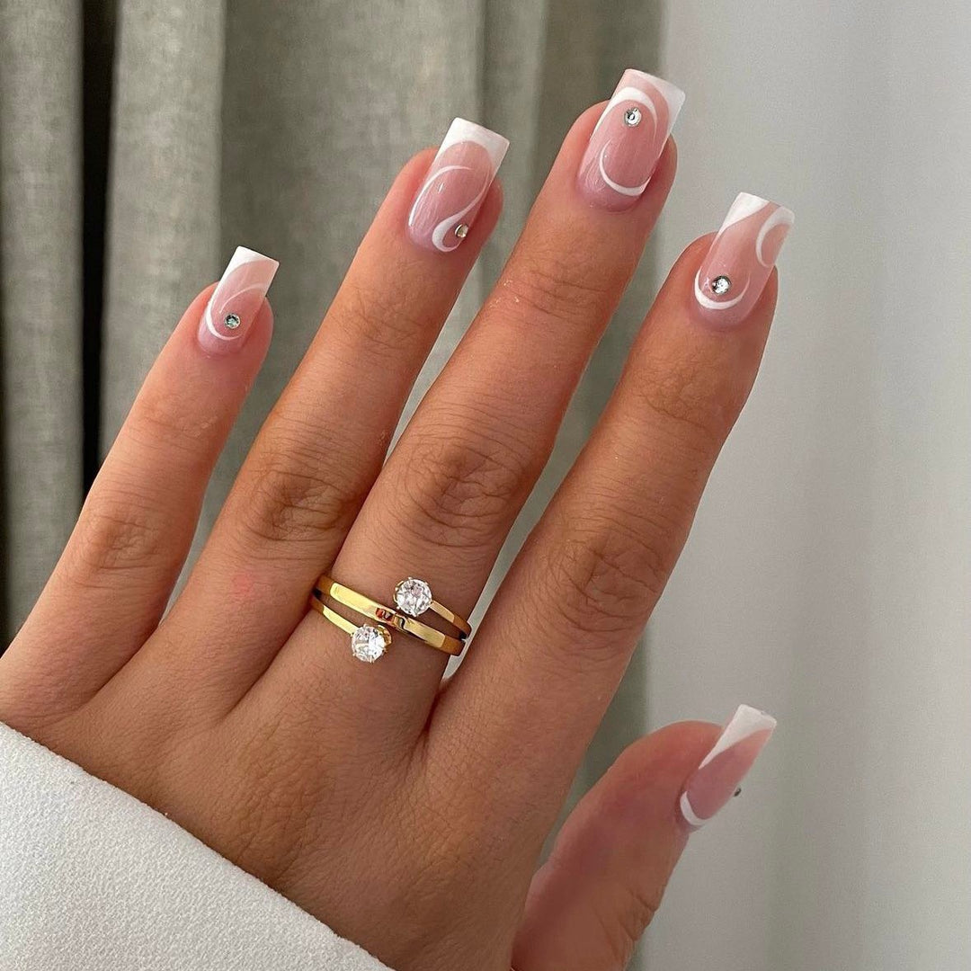 Artificial nail set with elegant French tips and glamorous rhinestone decorations Stornfield