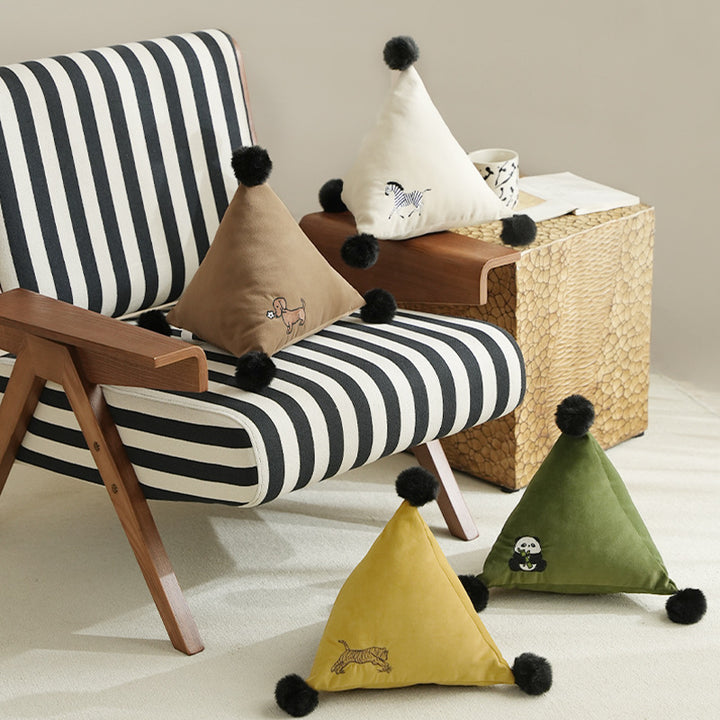 Triangular decorative pillow with zebra embroidery, pompom applications, and soft velvet cover Stornfield