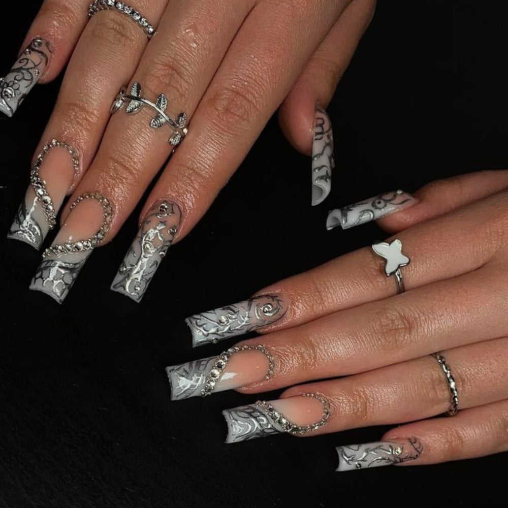 Artificial nails with elegant 3D pattern and radiant rhinestone decorations Stornfield